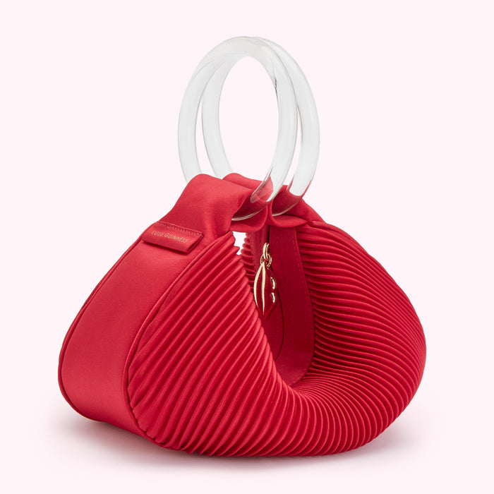 Red pleated satin Lulu Guinness handbag with clear Perspex handles.
