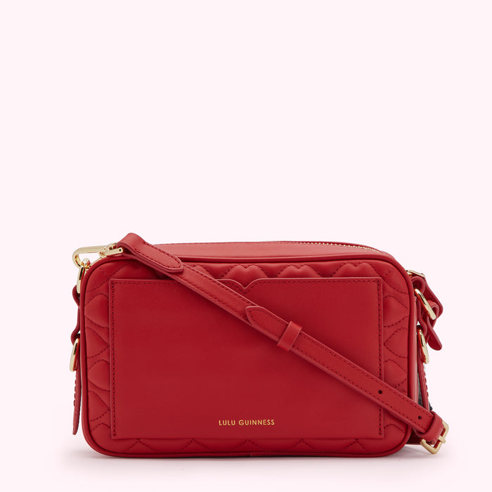 Red quilted crossbody bag with gold hardware and Lulu Guinness logo.