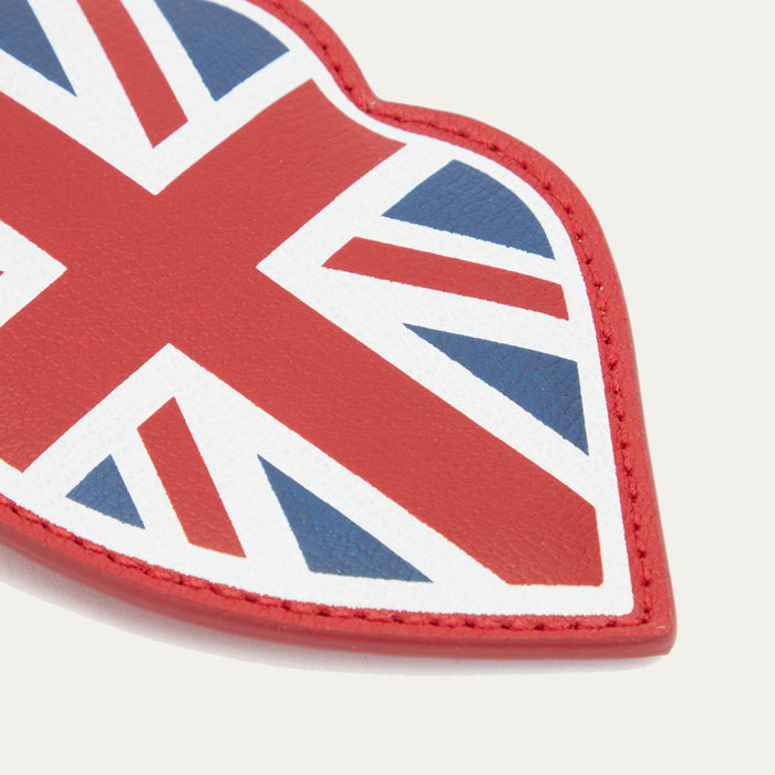 A close up image of a red leather luggage tag with a union jack print.