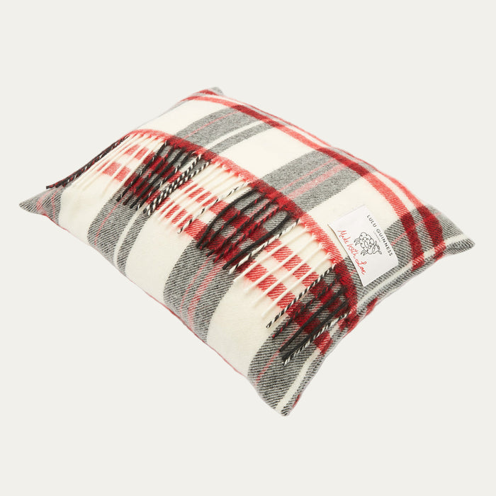 Rectangular cream cushion with red, grey and black plaid or tartan pattern and fringed edges. The Lulu Guinness logo is visible.