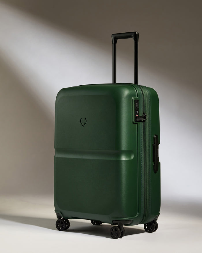 a green suitcase with wheels