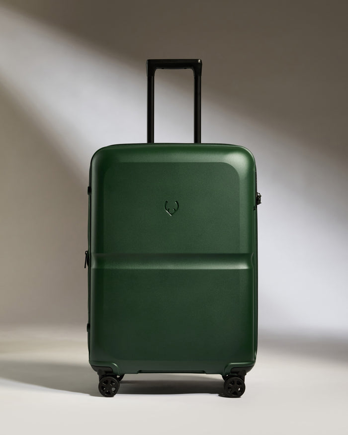 a green suitcase with wheels