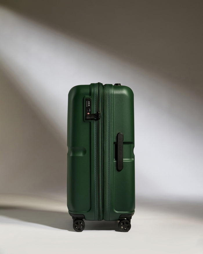 a green suitcase with wheels