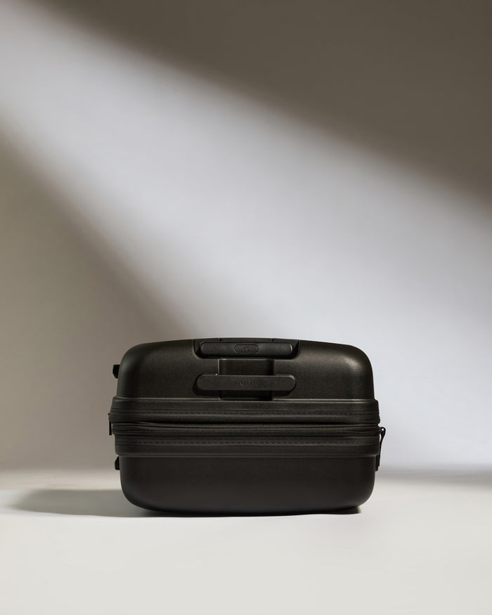 a black suitcase with a light shining on it