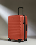 a red suitcase with wheels
