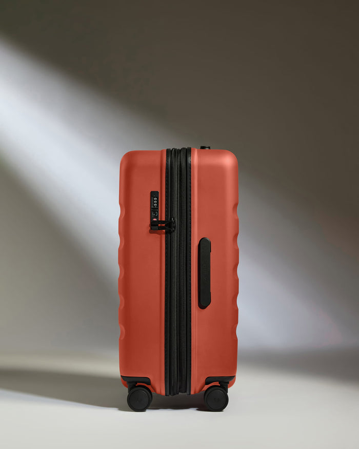 a red suitcase with wheels