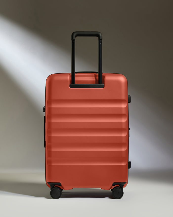 a red suitcase with black wheels