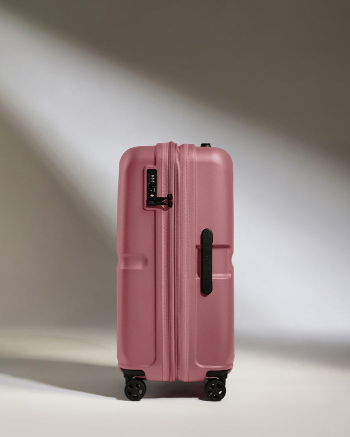 a pink suitcase with wheels