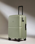 a green suitcase with wheels
