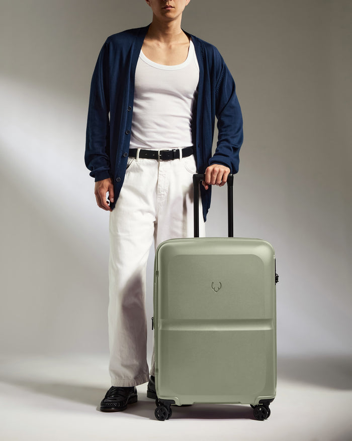 a man standing with a suitcase