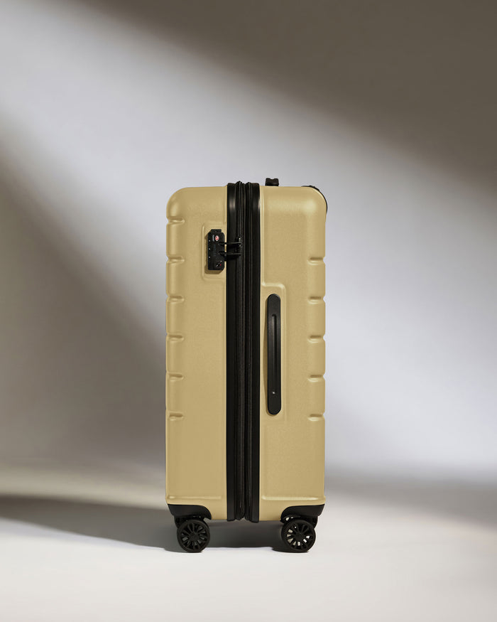 a tan suitcase with wheels
