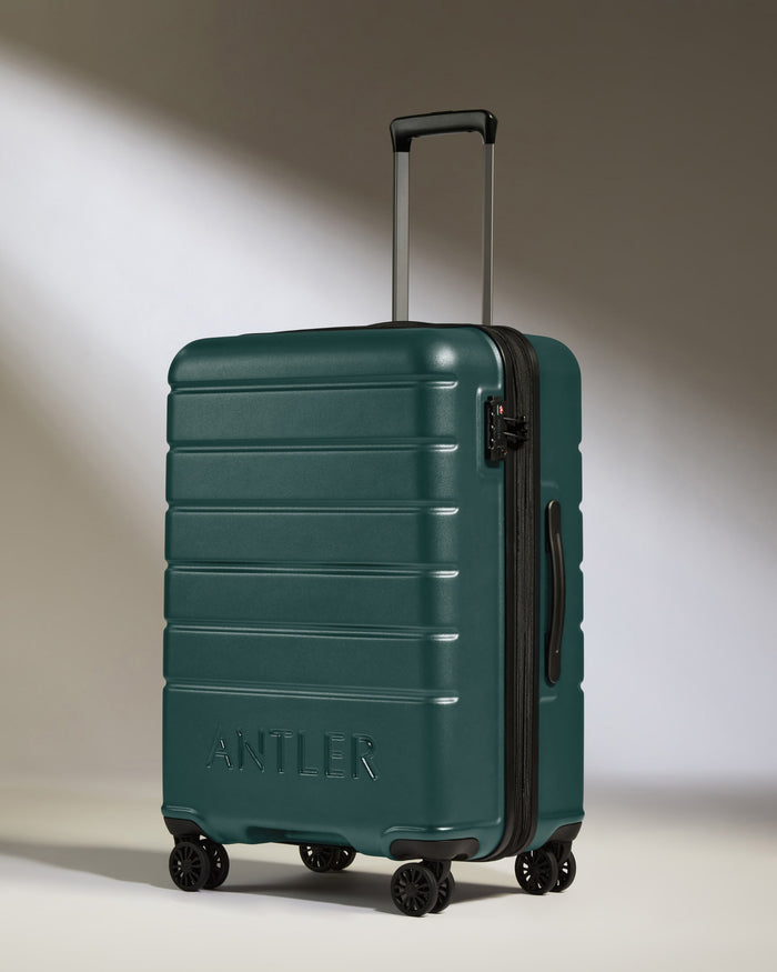 a green suitcase with wheels