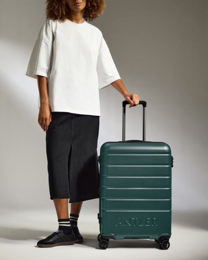 a person standing next to a suitcase