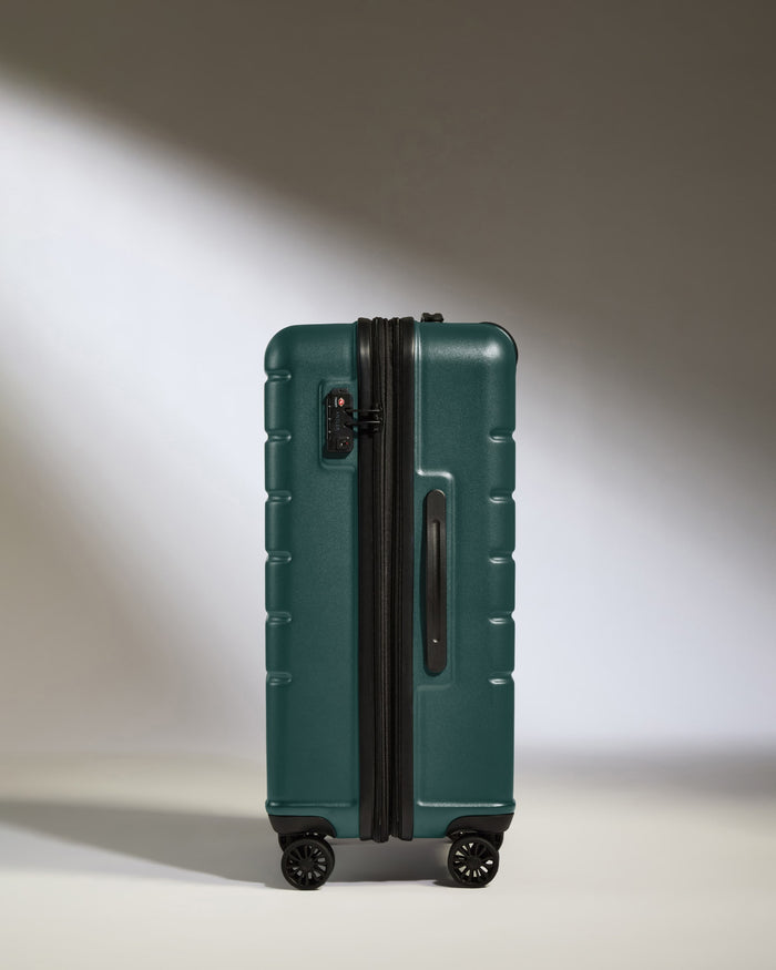 a green suitcase with wheels