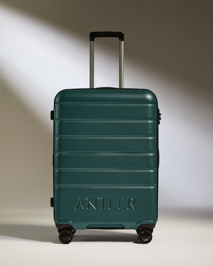 a green suitcase with wheels