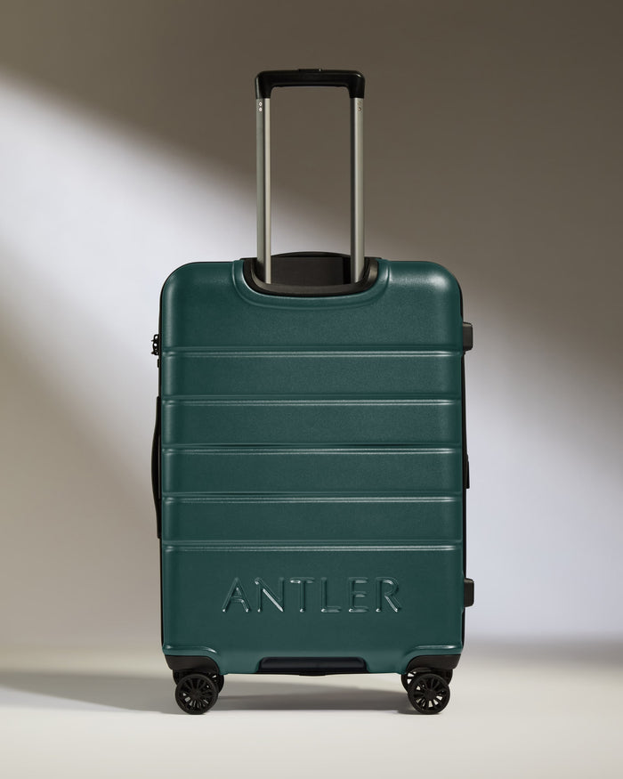 a green suitcase with handle