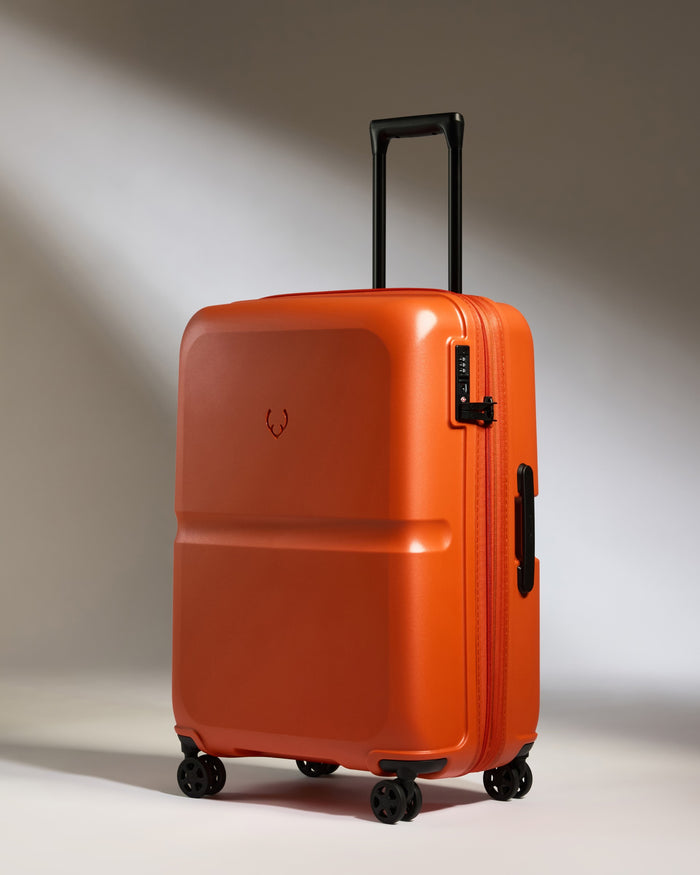 an orange suitcase with wheels