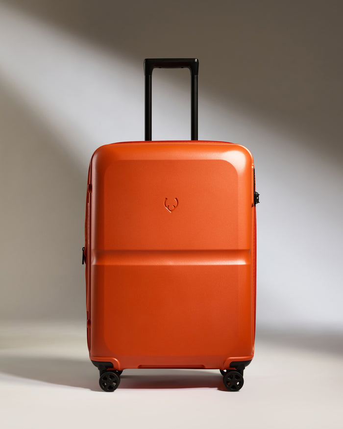 an orange suitcase with wheels