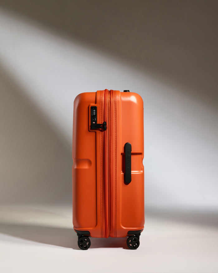an orange suitcase with wheels