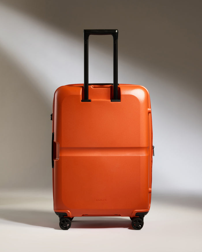 an orange suitcase with black handles
