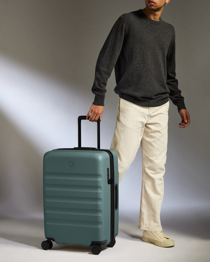 a man standing next to a suitcase