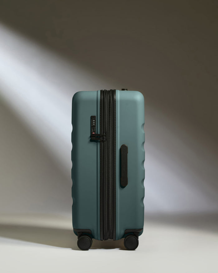 a suitcase with wheels and light shining on it