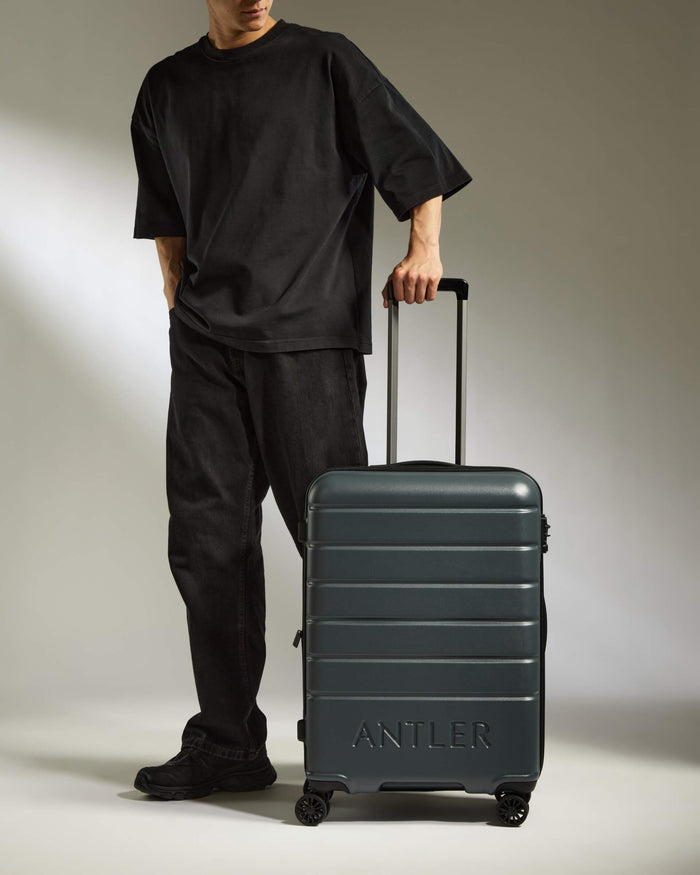 a man standing with a suitcase