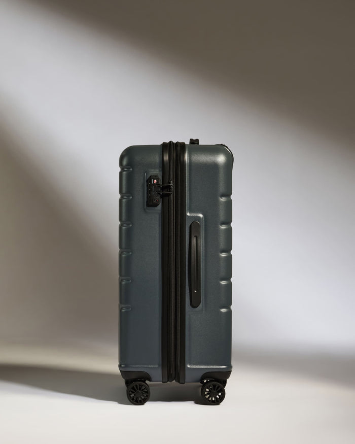 a suitcase on wheels with light shining on it