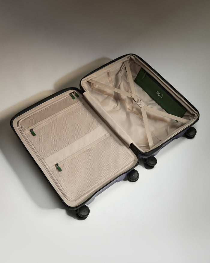 a suitcase with wheels and a green wallet inside