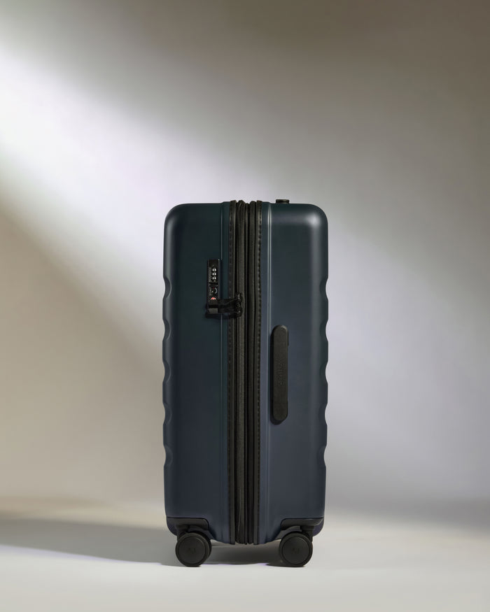 a suitcase on wheels with a light shining on it