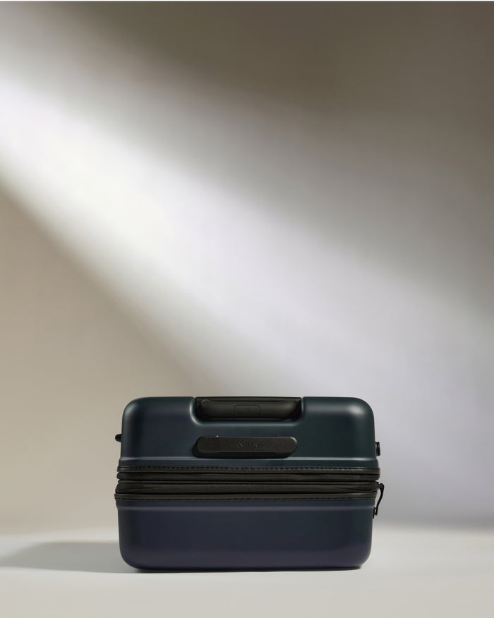 a blue suitcase with a light shining on it