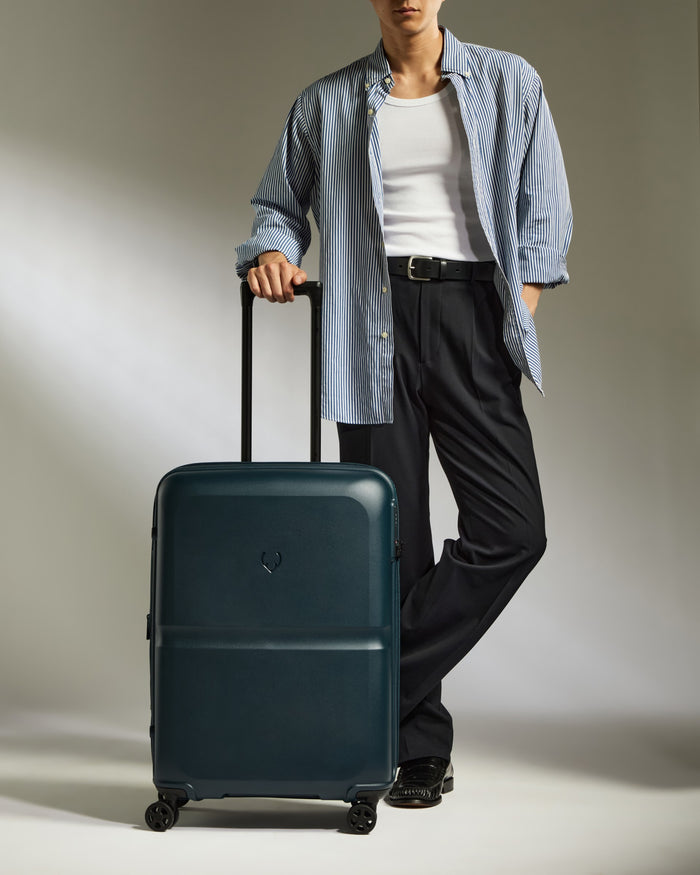 a man standing with a suitcase