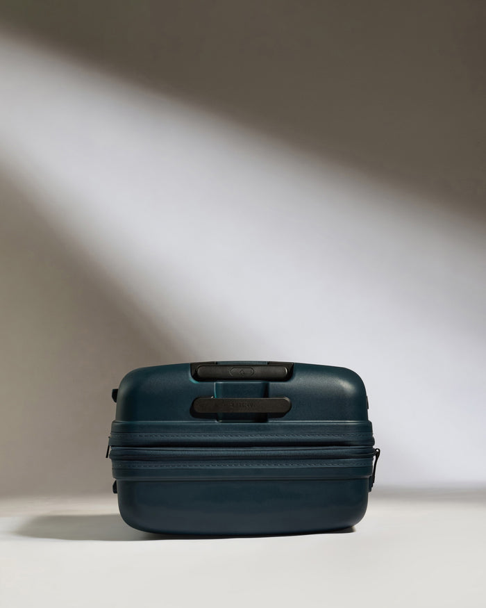 a blue suitcase with a light shining on it