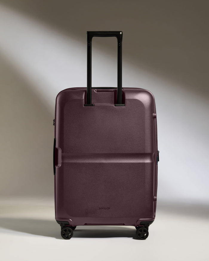 a purple suitcase with wheels