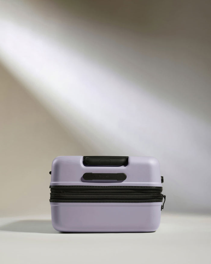 a purple suitcase with a black zipper
