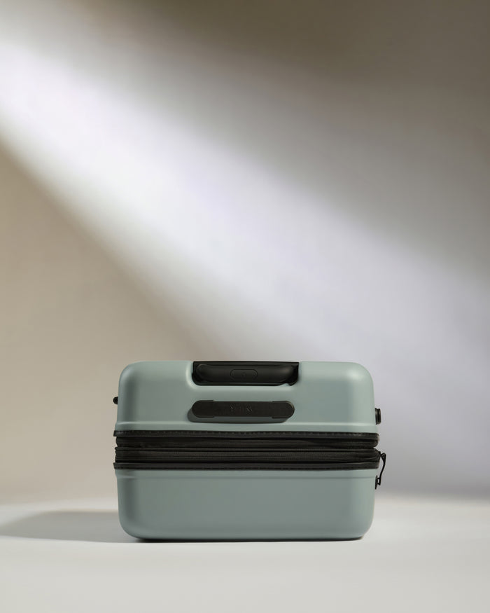 a light shining through a grey suitcase