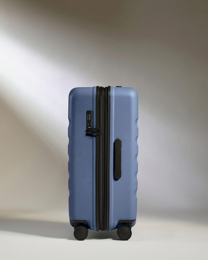 a blue suitcase with wheels