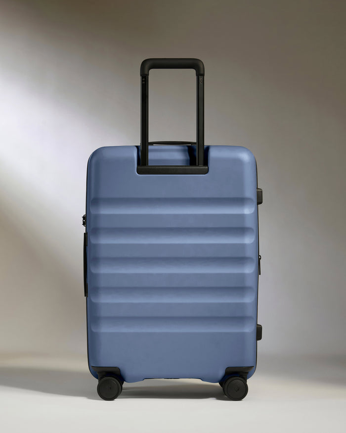a blue suitcase with black handle