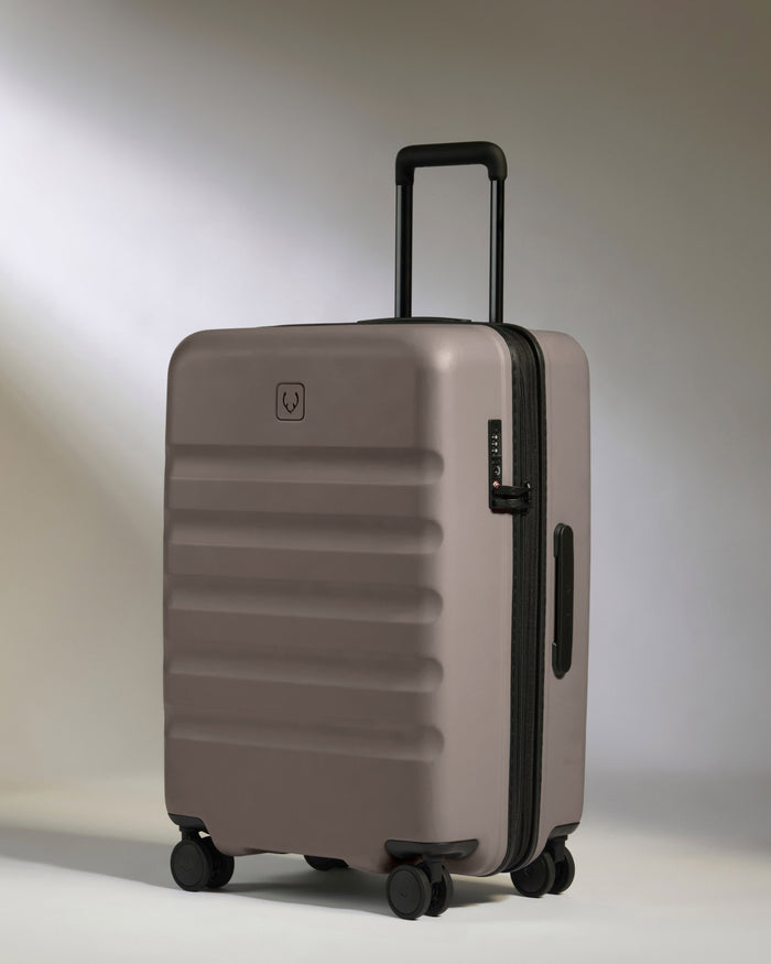 a grey suitcase with wheels