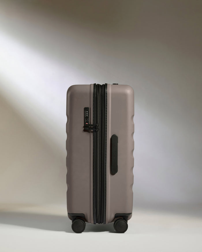 a grey suitcase with wheels