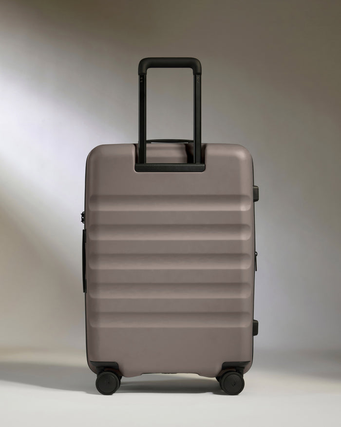 a grey suitcase with black handle