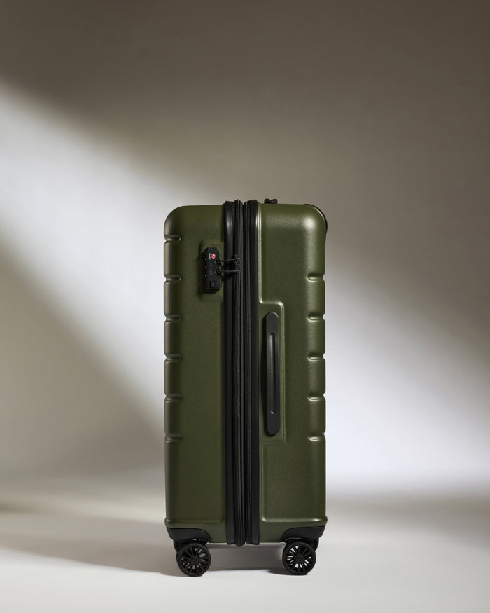 a green suitcase with wheels