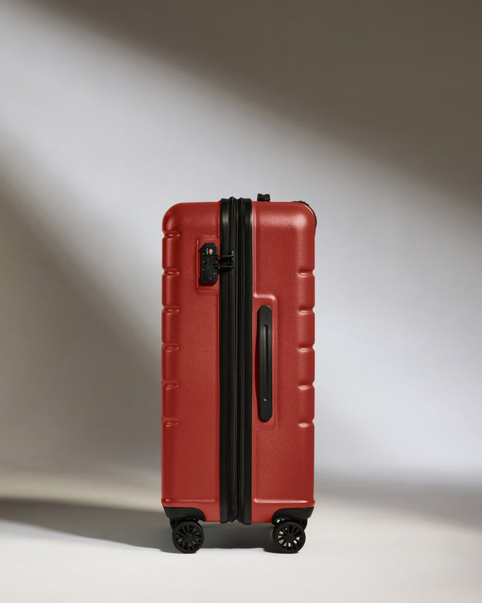 a red suitcase with wheels