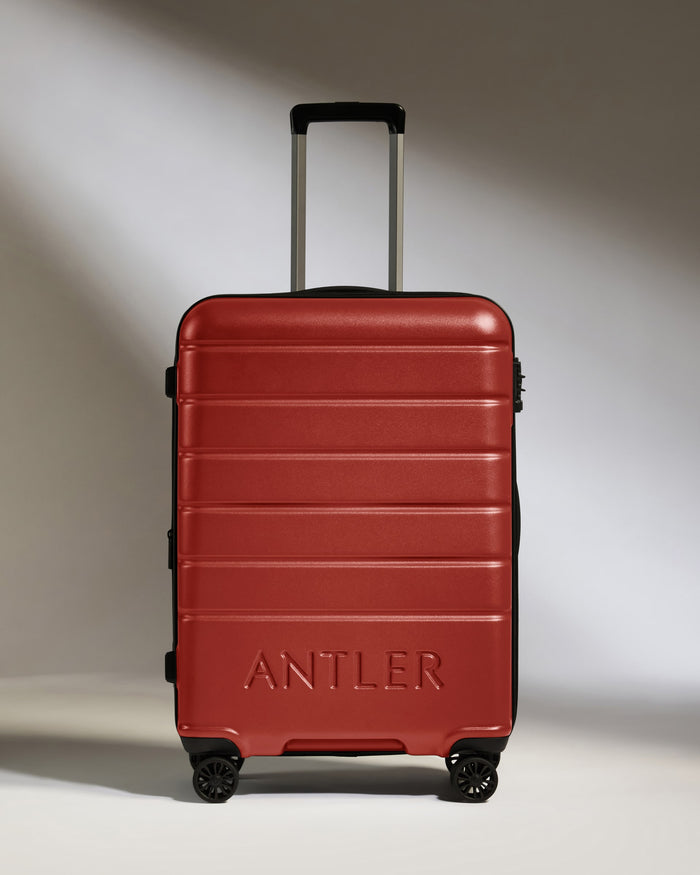 a red suitcase with handle