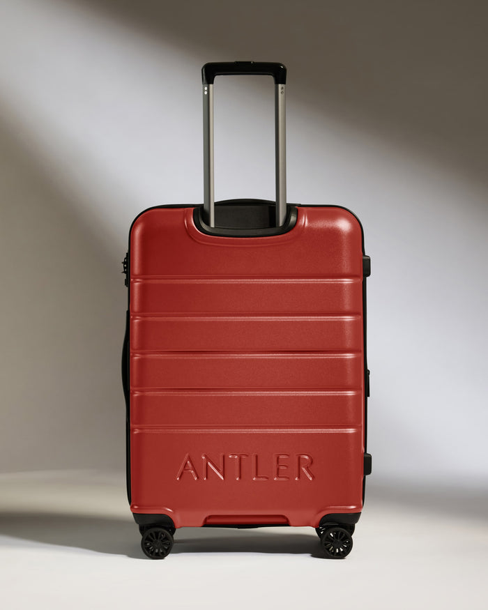 a red suitcase with handle