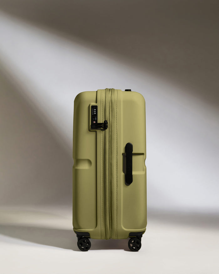 a green suitcase with wheels