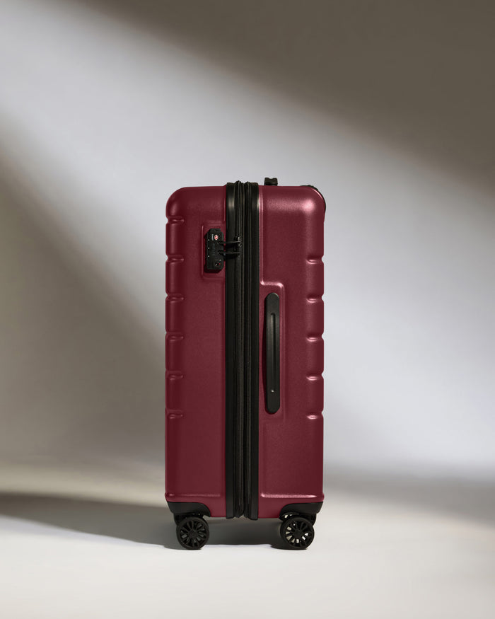 a red suitcase with wheels
