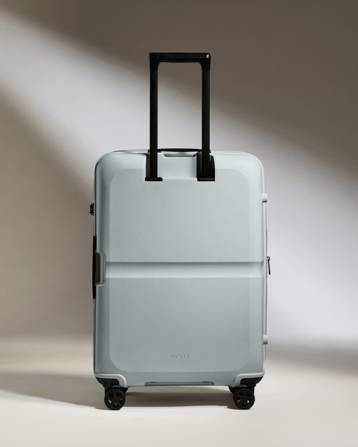 a grey suitcase with black handles