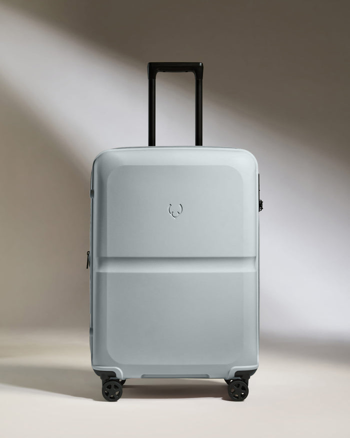 a grey suitcase with black wheels