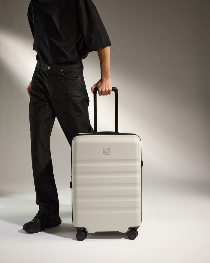 a person holding a luggage bag